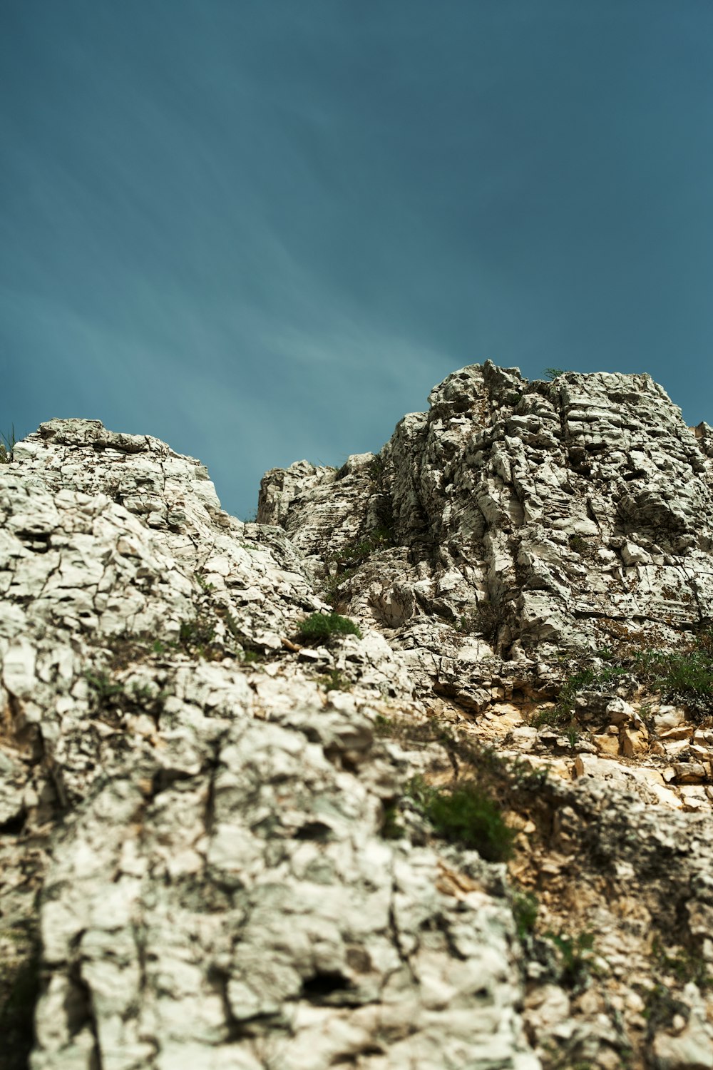 a rock formation with a blue sky in the background