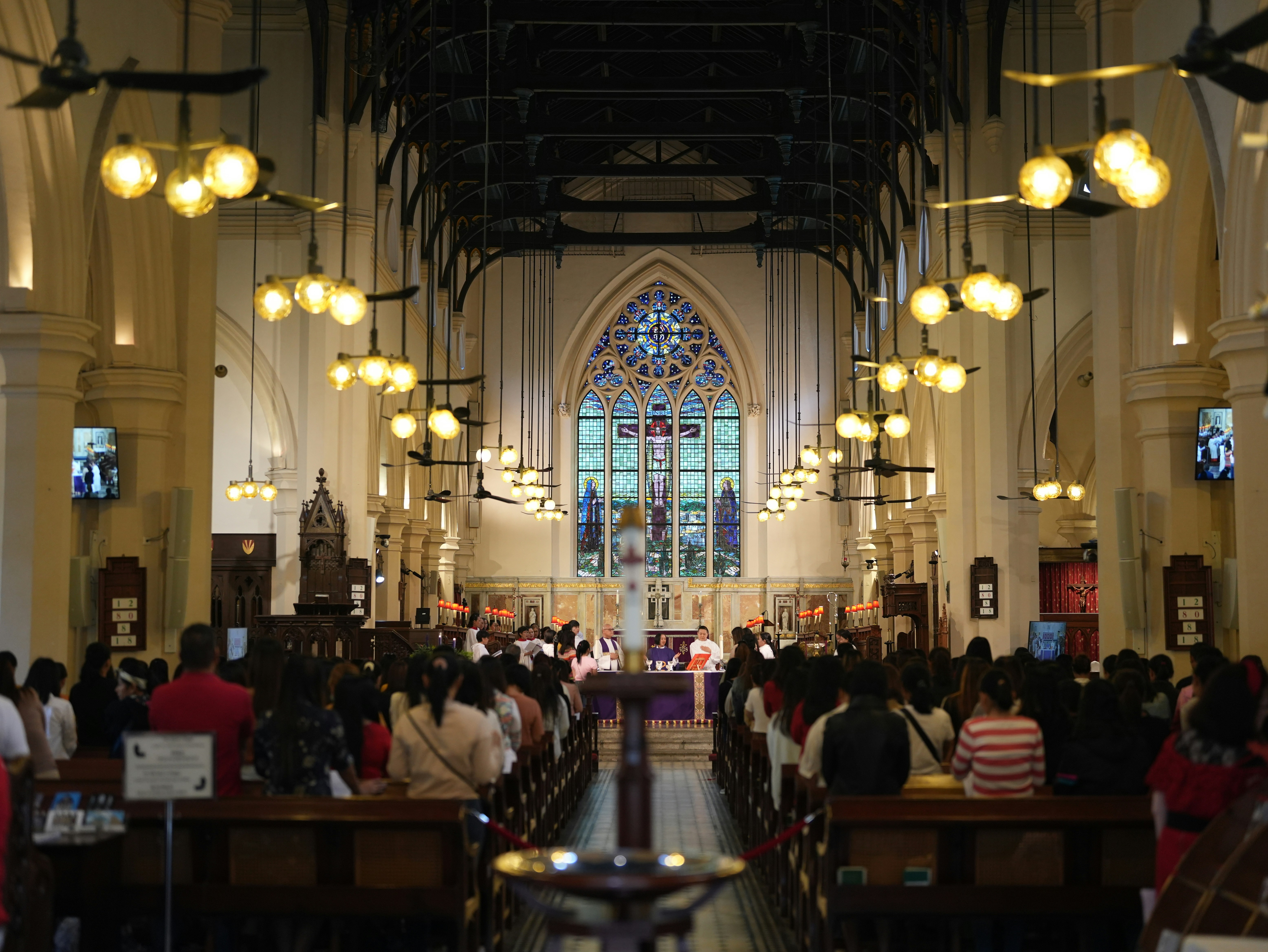 Church interior with stained light and seated congregation