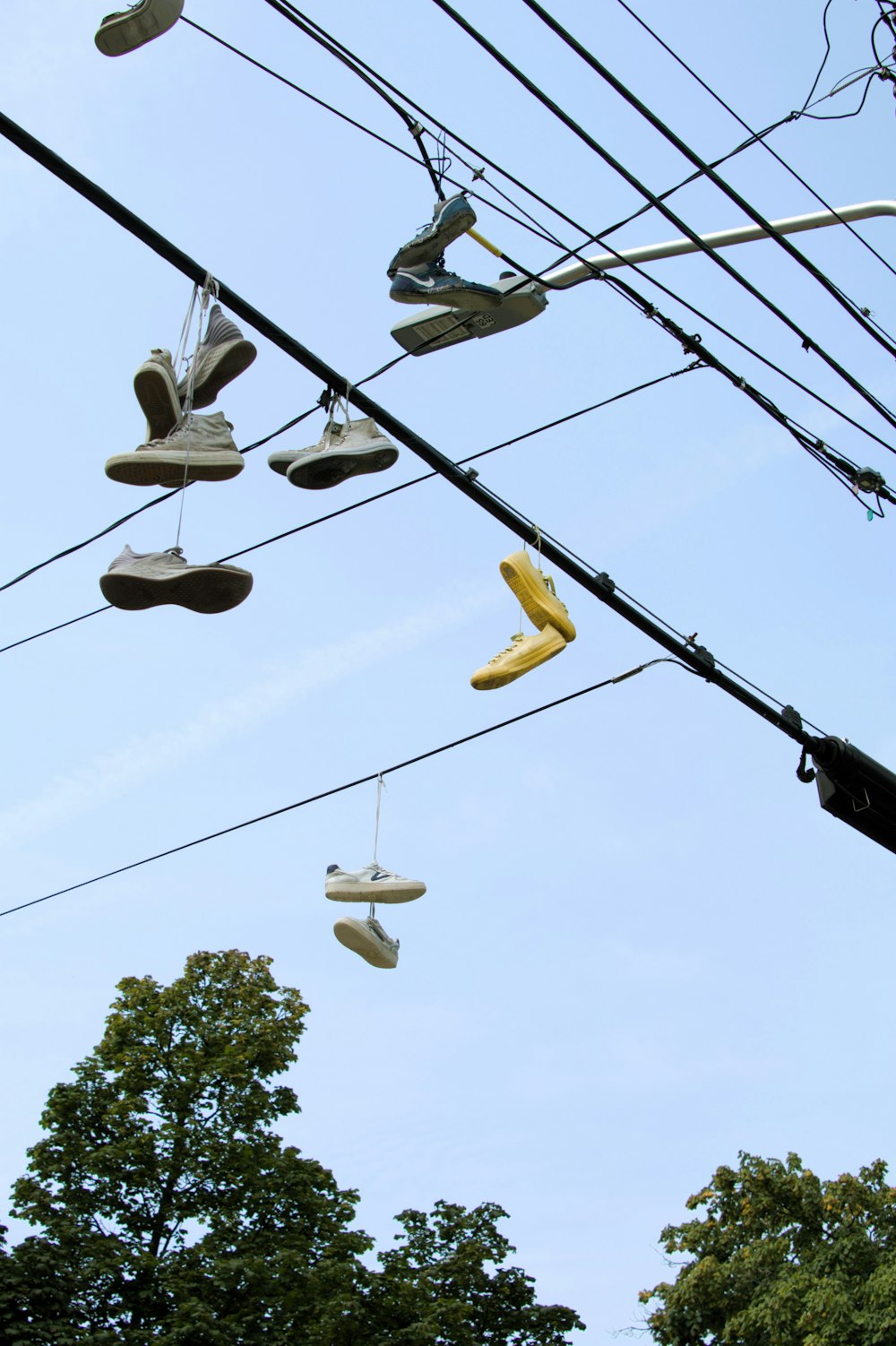 a pair of shoes hanging from a power line