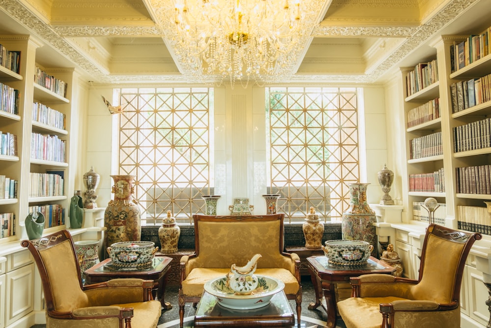 a living room filled with furniture and a chandelier