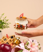 a person is holding a jar of food