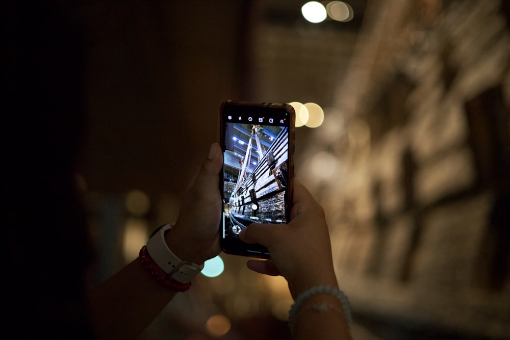 a person taking a picture with a cell phone