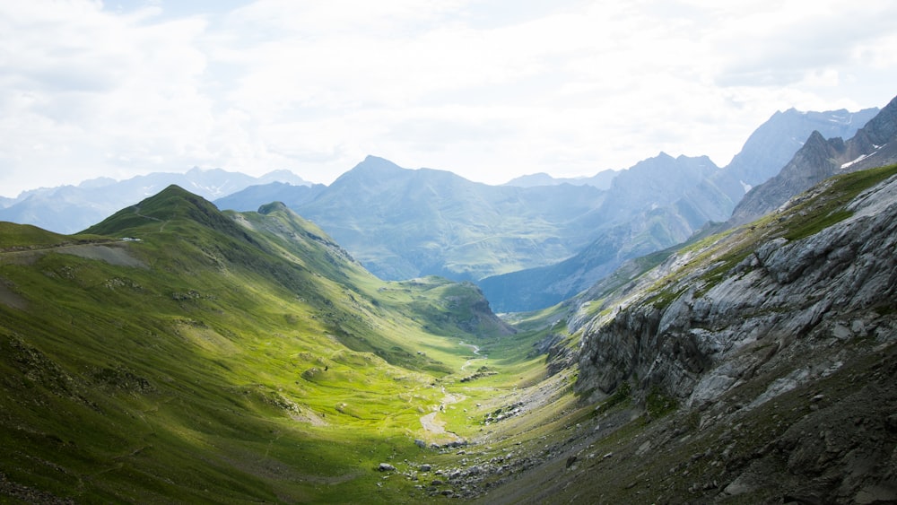 a view of a valley with mountains in the background