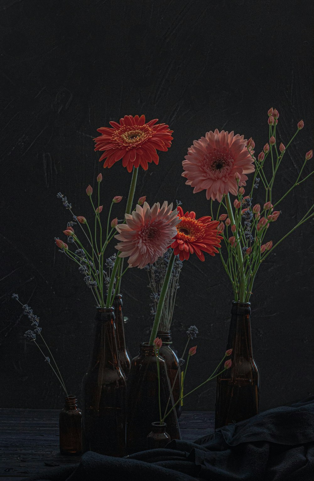 a group of vases filled with flowers on top of a table