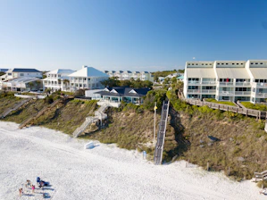 an aerial view of a beach resort with a staircase leading to the beach