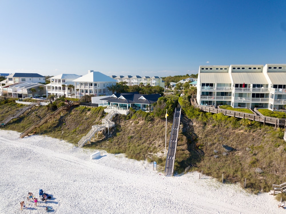 an aerial view of a beach resort with a staircase leading to the beach