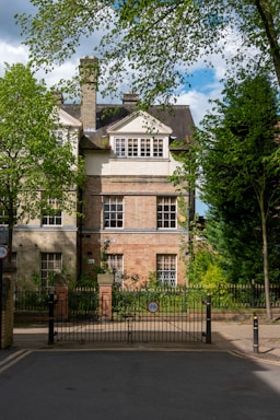 a large brick building with a gate in front of it