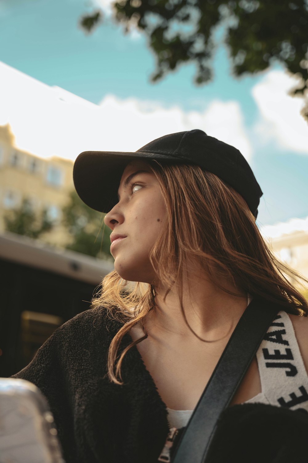 a woman wearing a black hat and a black bag