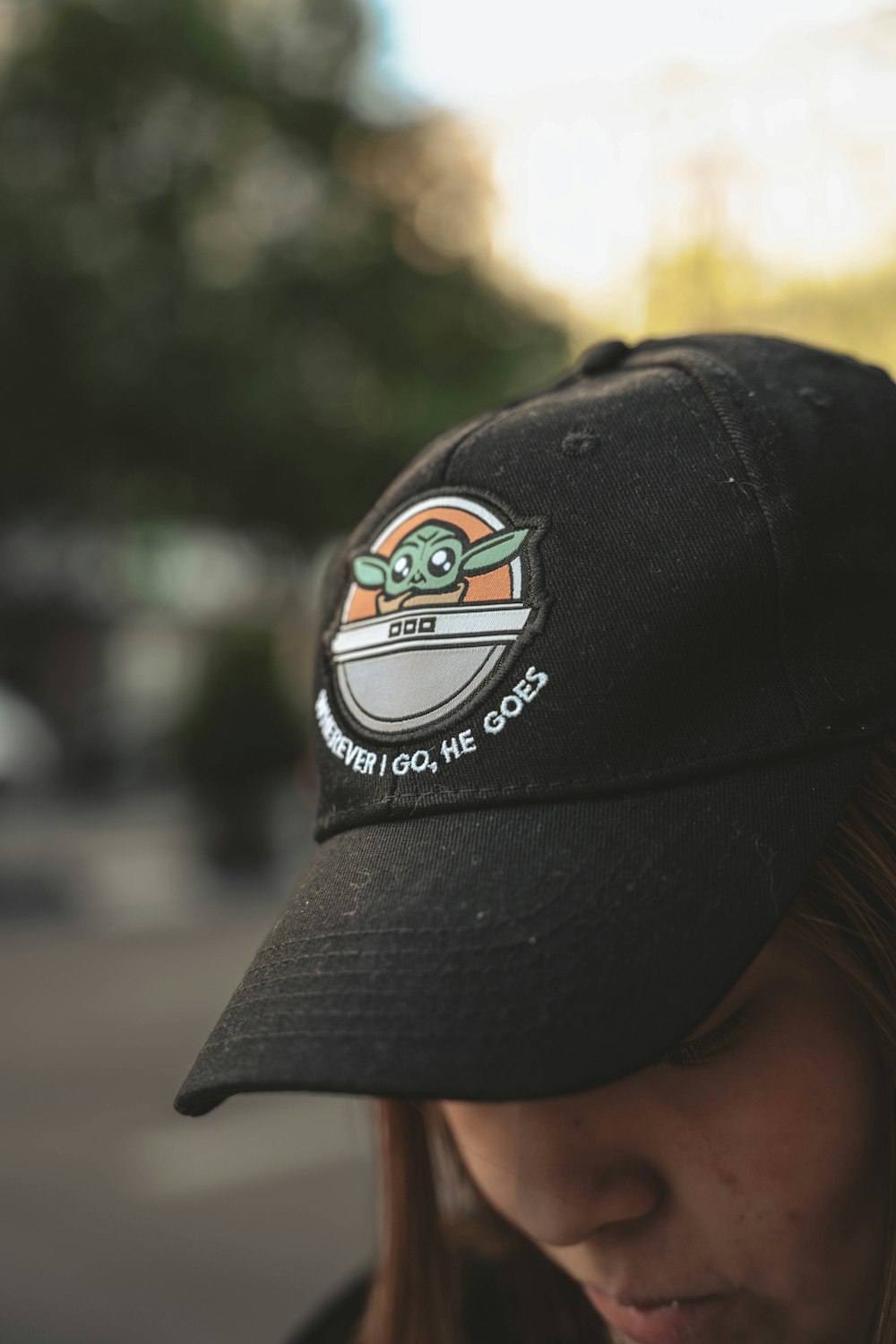 a girl wearing a hat with a star wars sticker on it