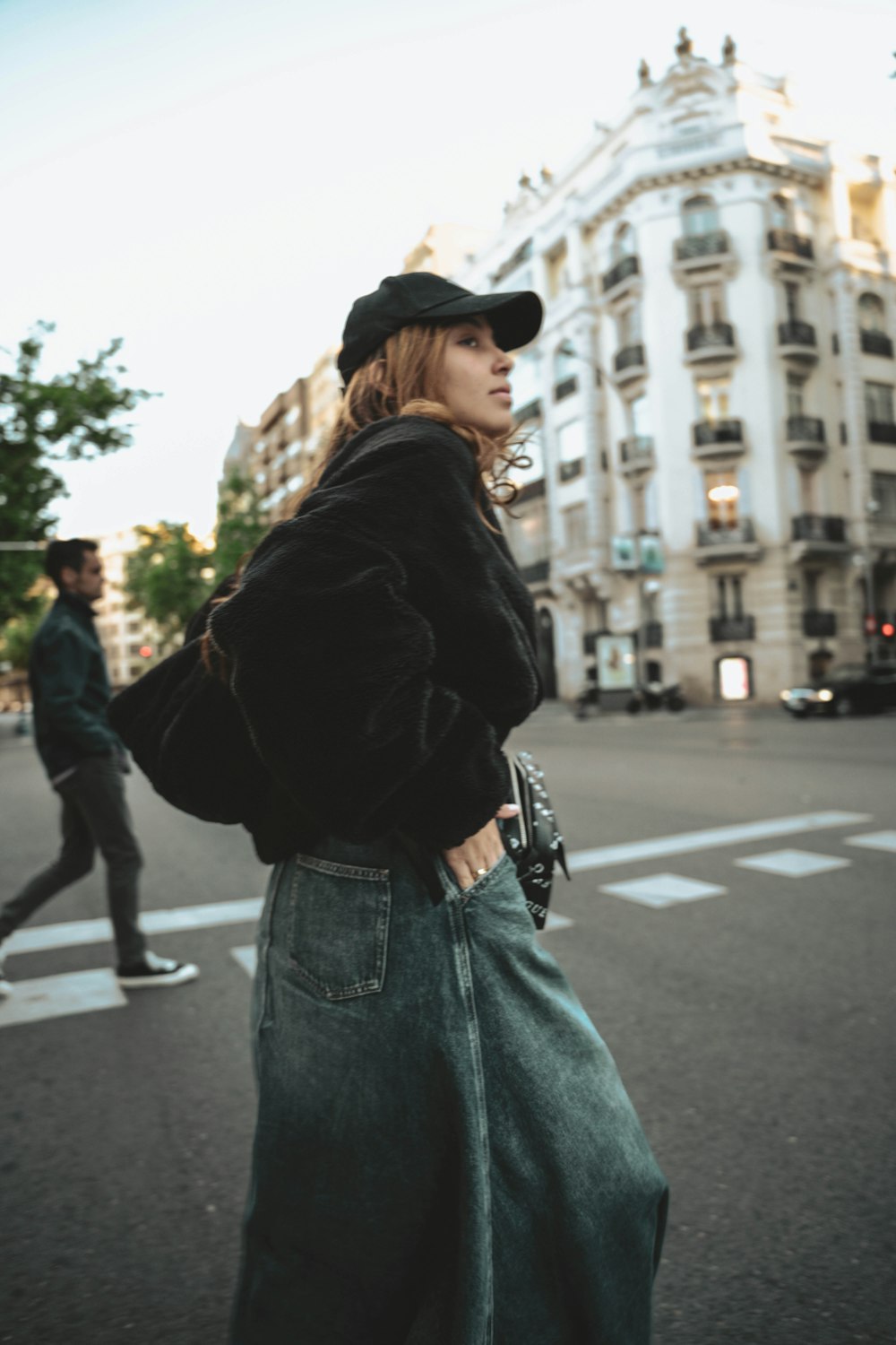 a woman standing on the side of a road