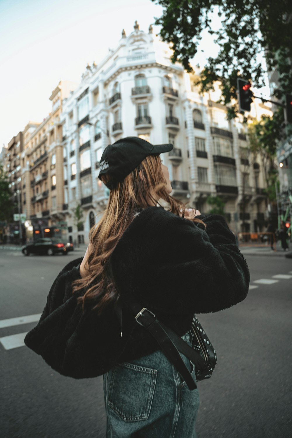 a woman standing on the side of the road