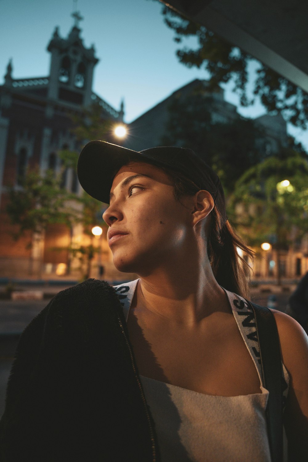 a woman wearing a black hat and a black jacket