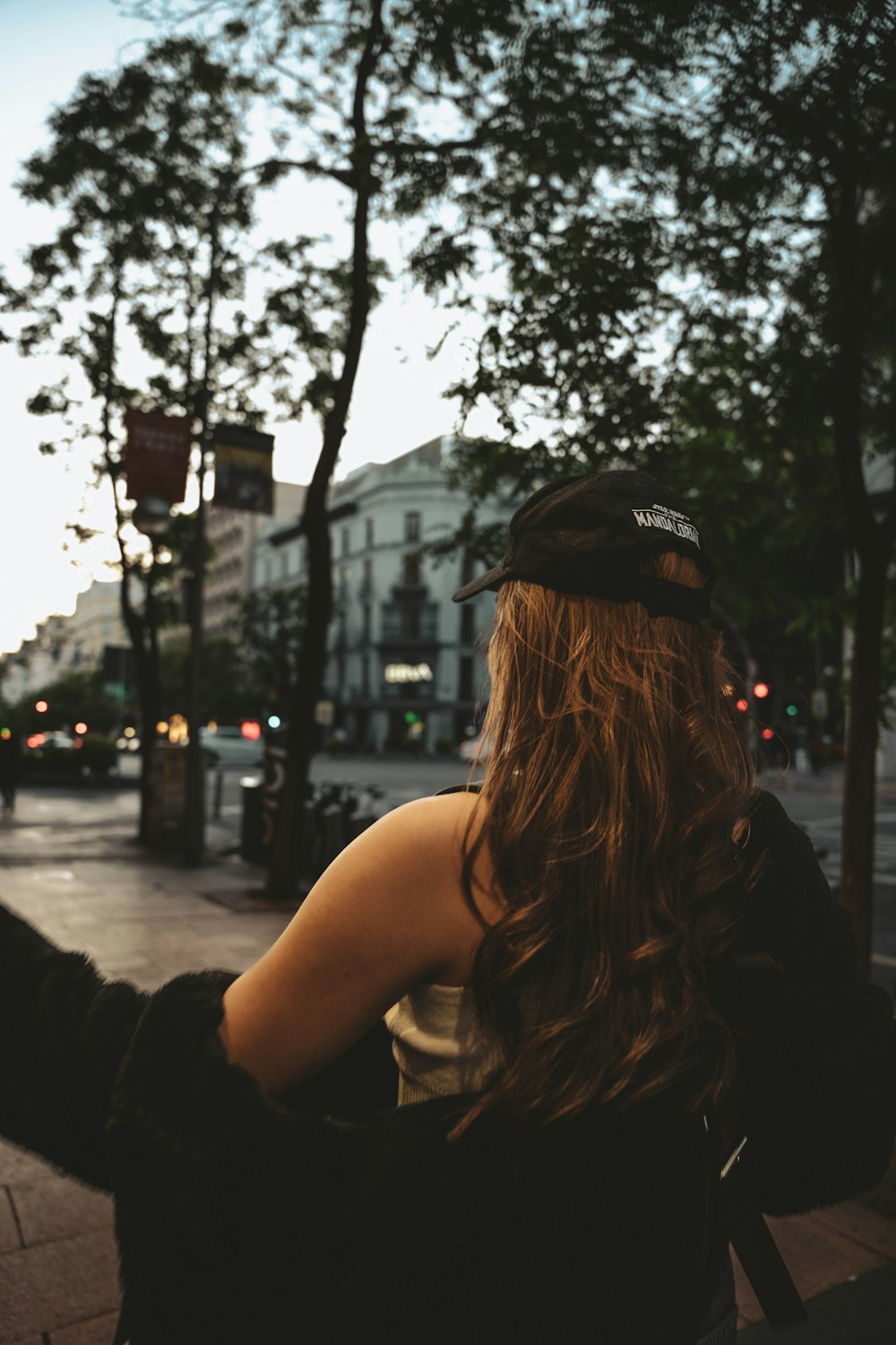 a woman sitting on a bench on a city street