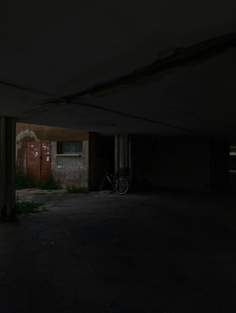 an empty parking garage with a bicycle parked in it