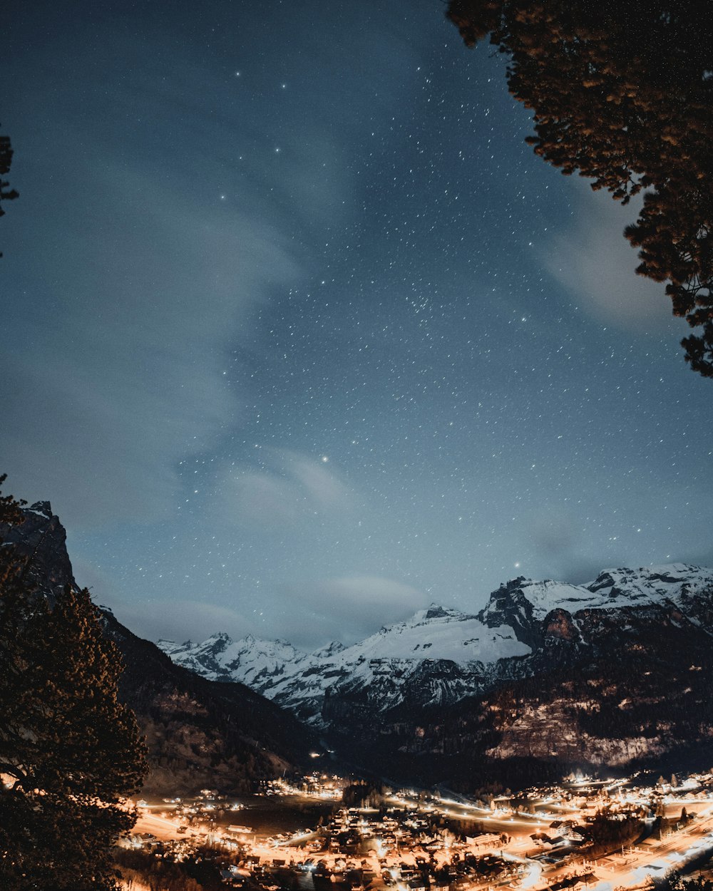 a night time view of a snowy mountain range