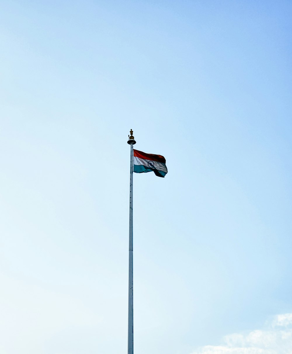 a tall flag pole with a flag on top of it
