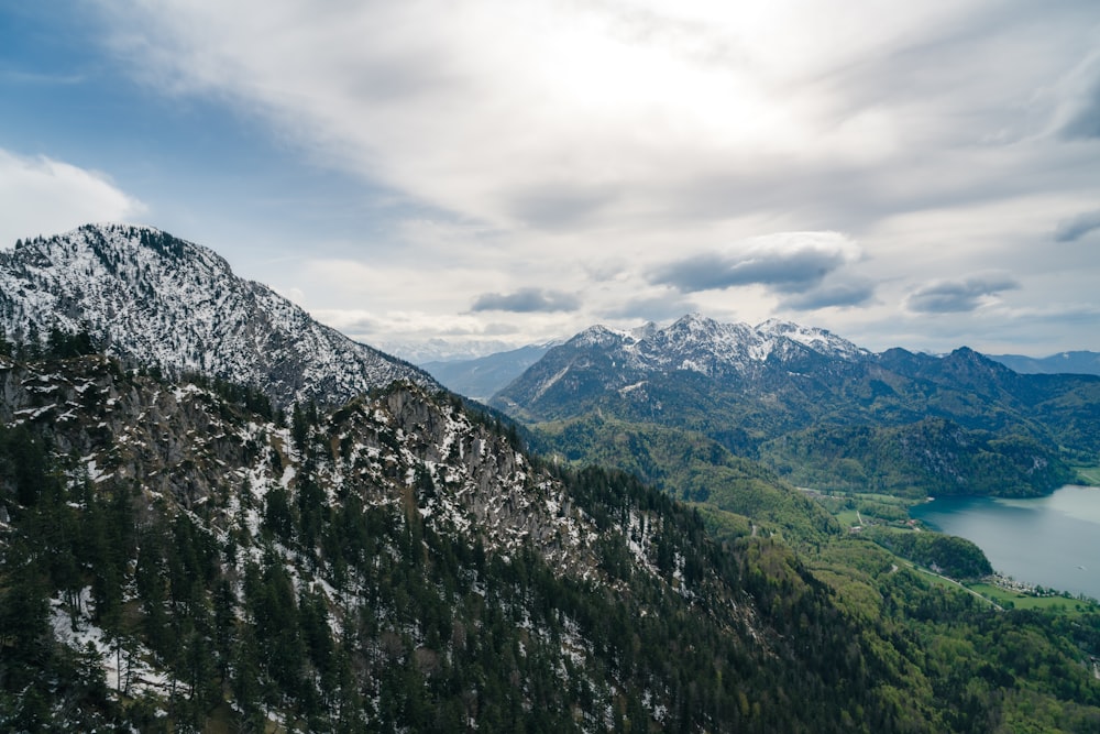 a view of a mountain range with a lake in the foreground