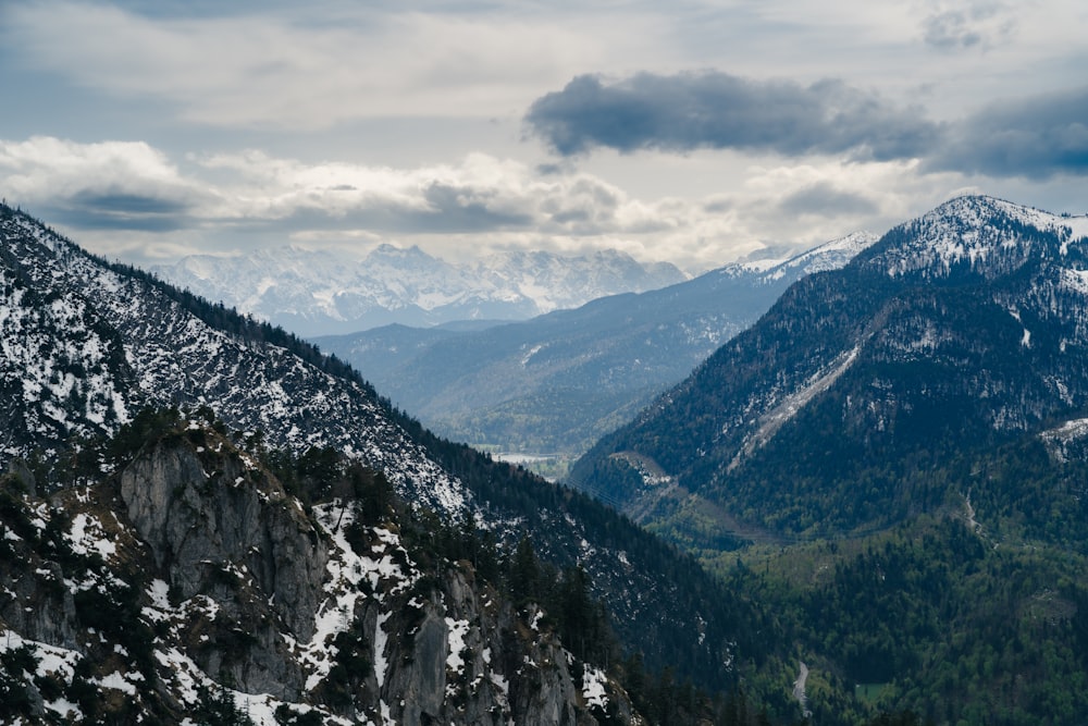 a mountain range with snow covered mountains in the distance