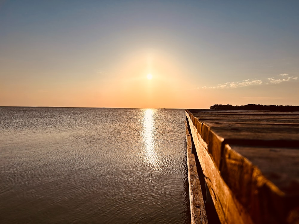 the sun is setting over a body of water