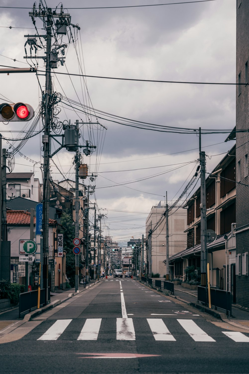 a red traffic light sitting above a street