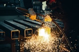 welder working on a piece of metal in a factory