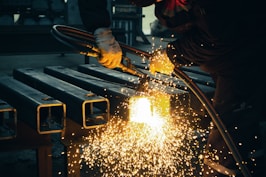 welder working on a piece of metal in a factory