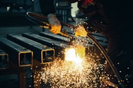 welder working on a piece of metal in a factory