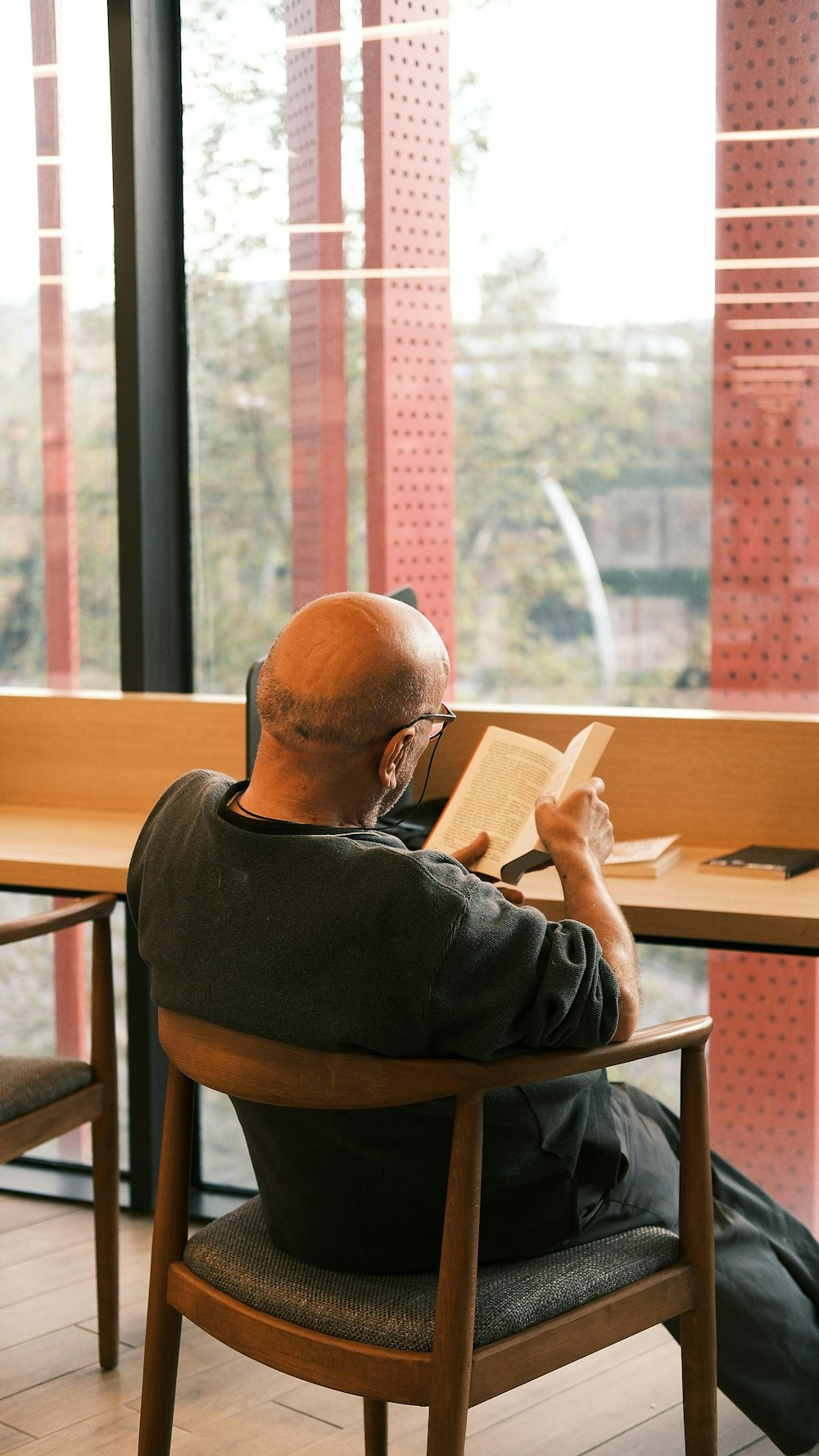 a man sitting in a chair reading a book