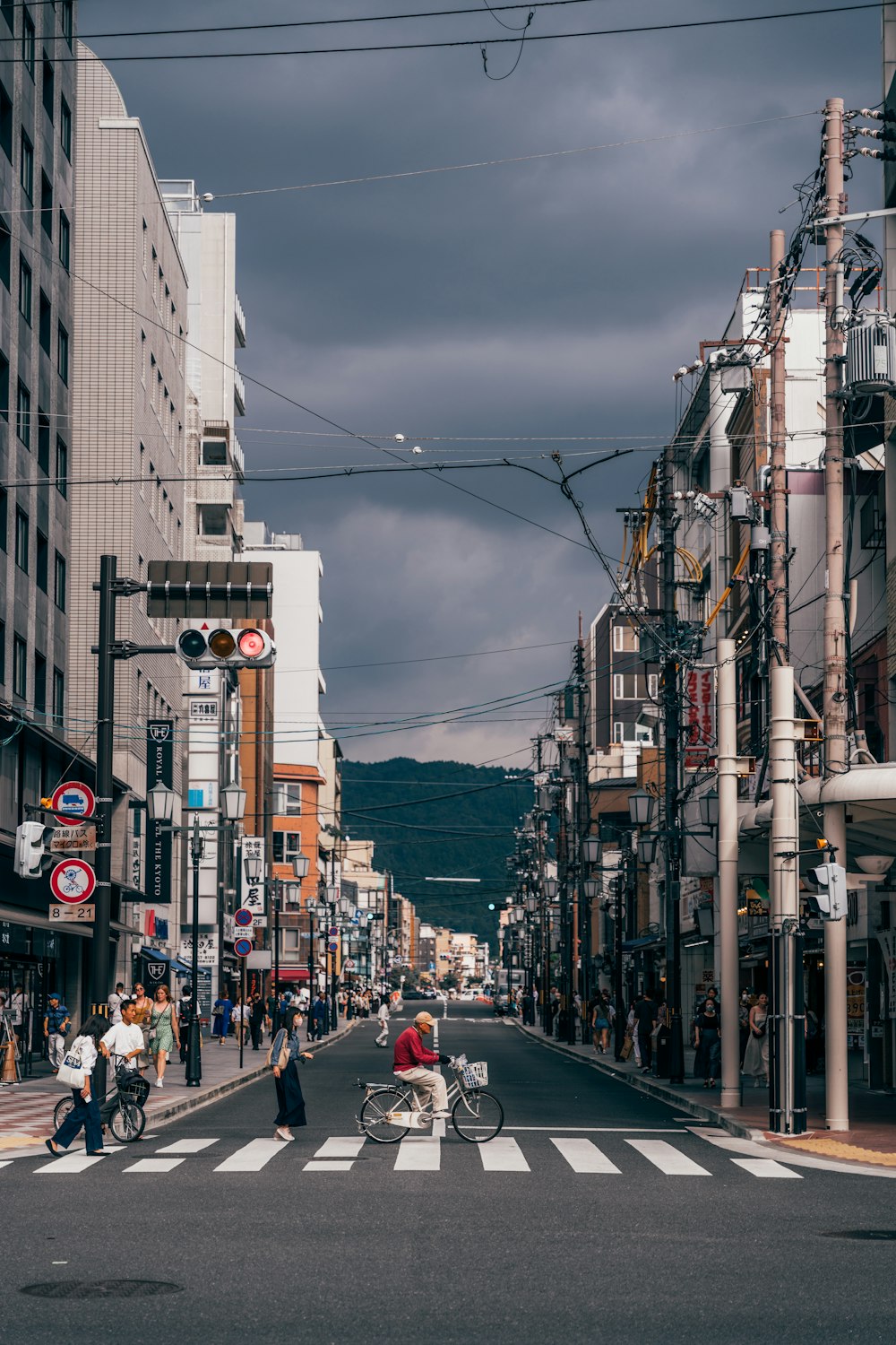 a city street with people crossing the street