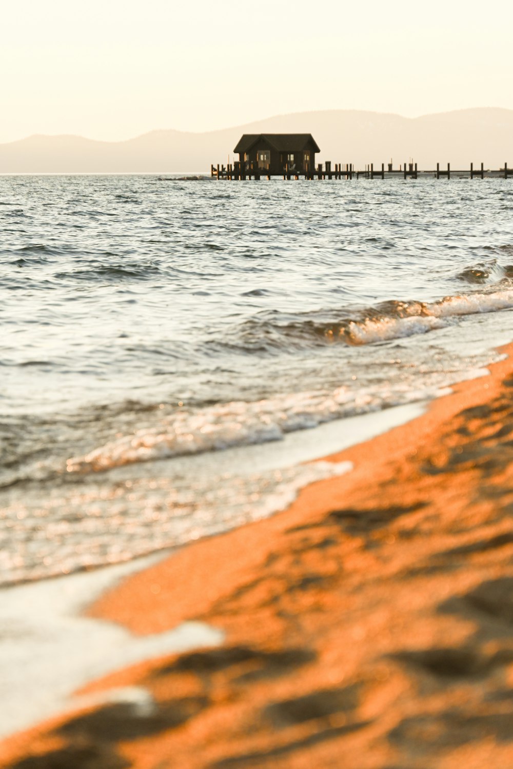 a beach with a house in the distance