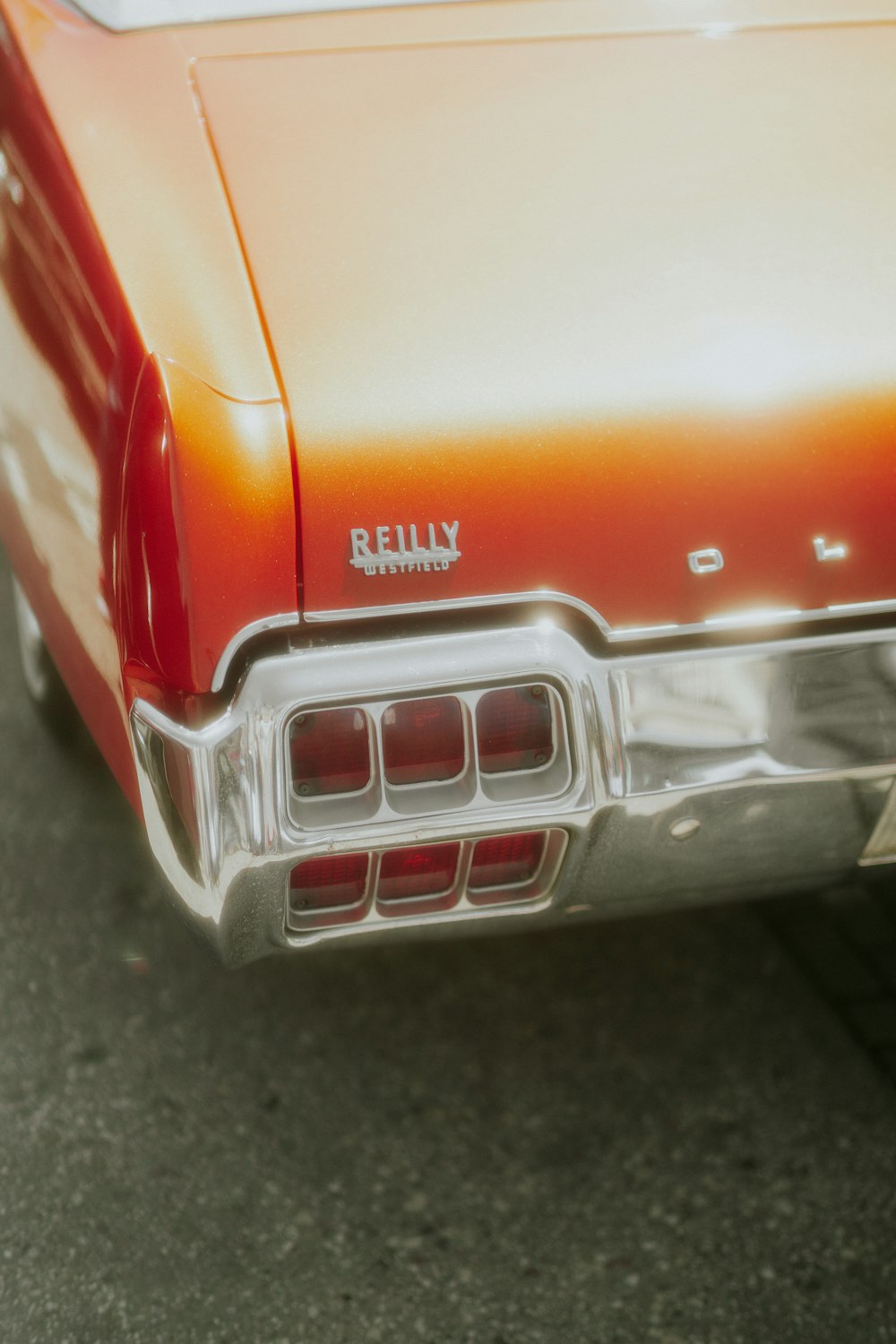 an orange and white car parked in a parking lot