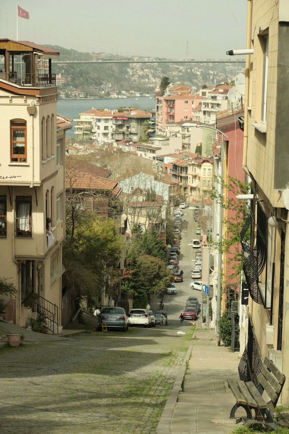 a view of a street with cars parked on the side of it