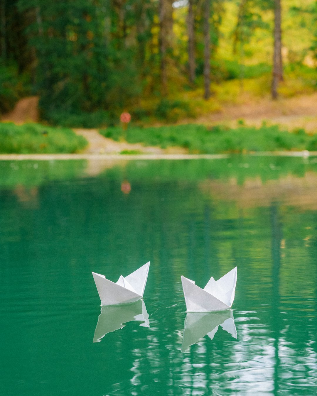 Paper boats floating on a pond shot for Outside Project.