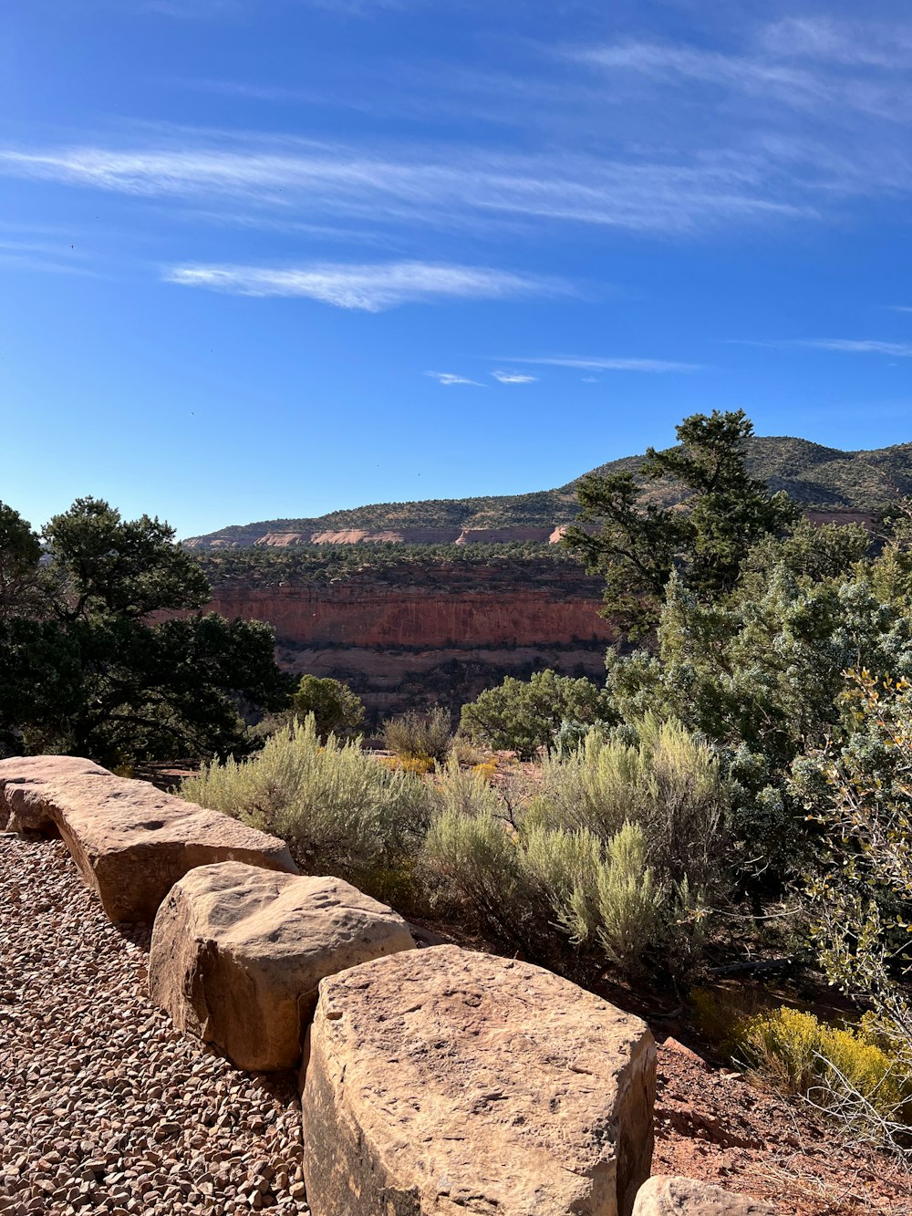 a stone bench sitting on top of a rocky hillside