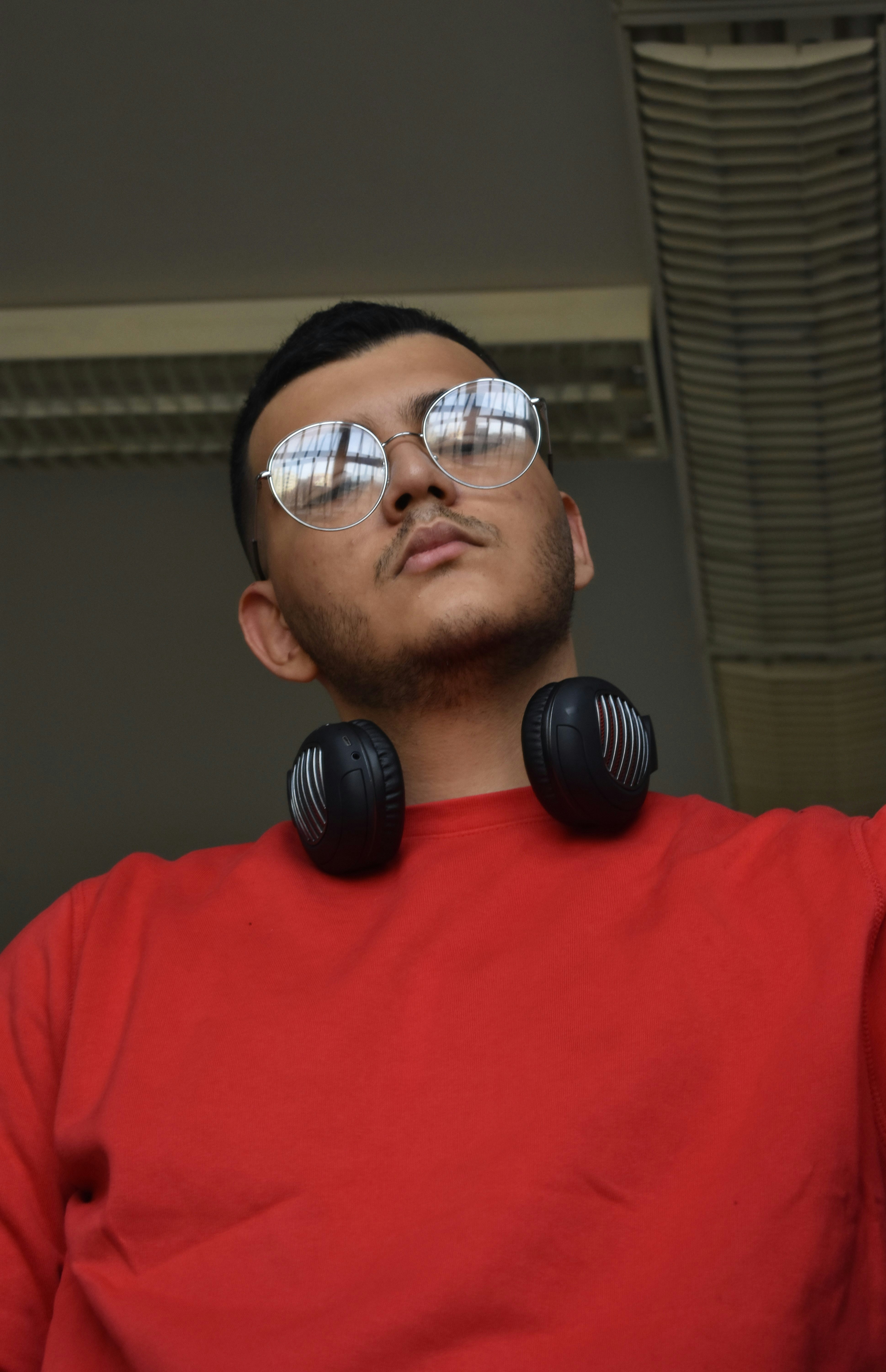 a man wearing headphones and a red shirt