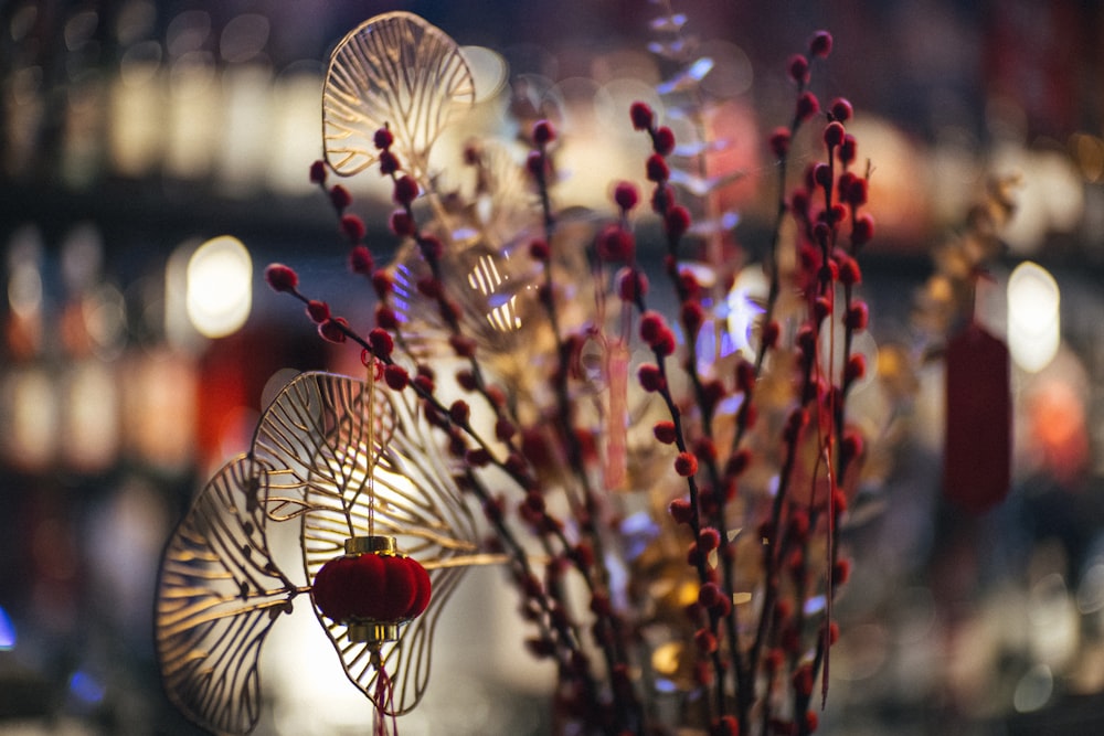 a vase filled with red flowers on top of a table