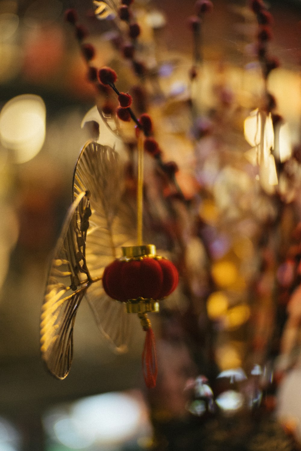 a vase filled with flowers and a butterfly on top of it