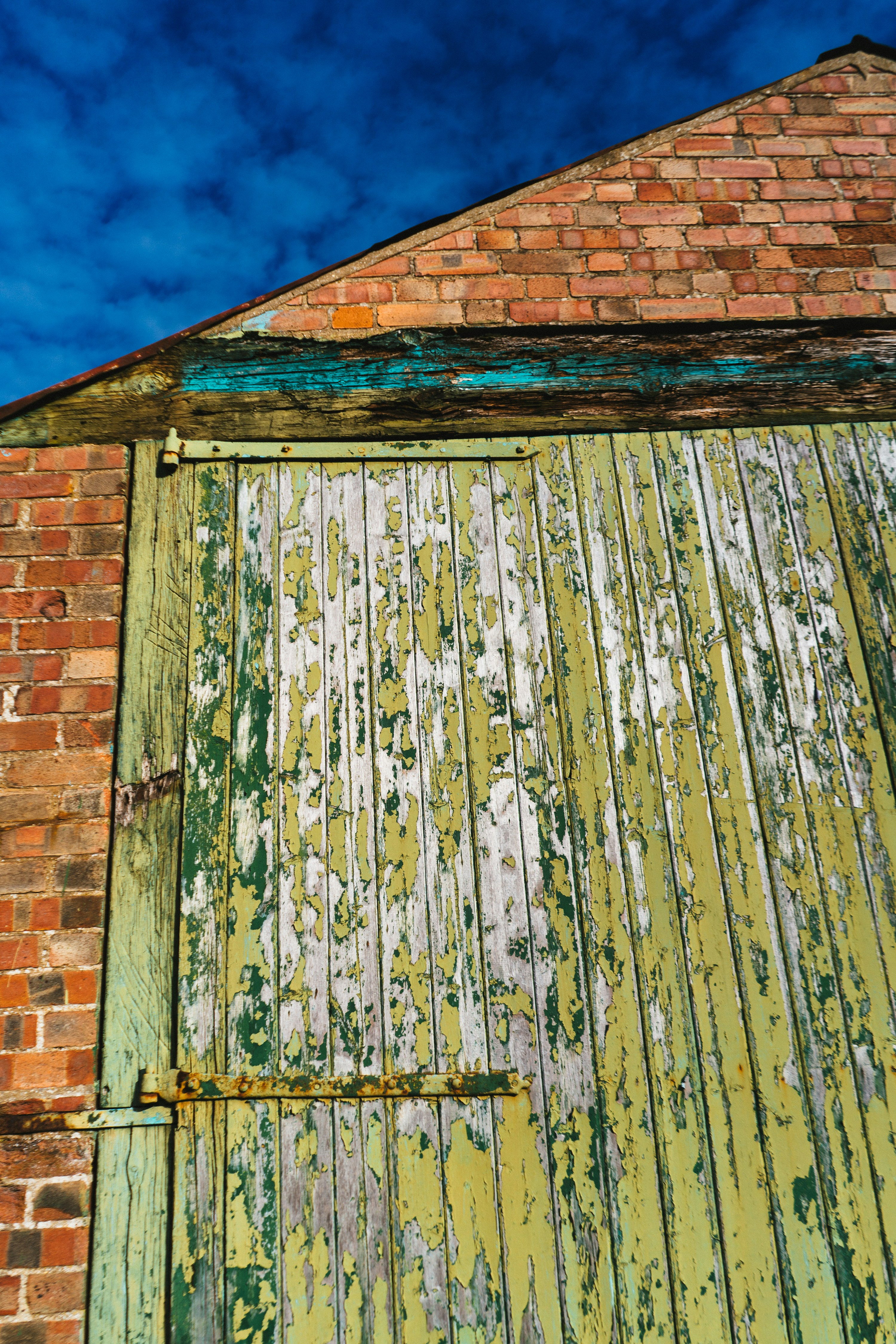 an old brick building with a green door