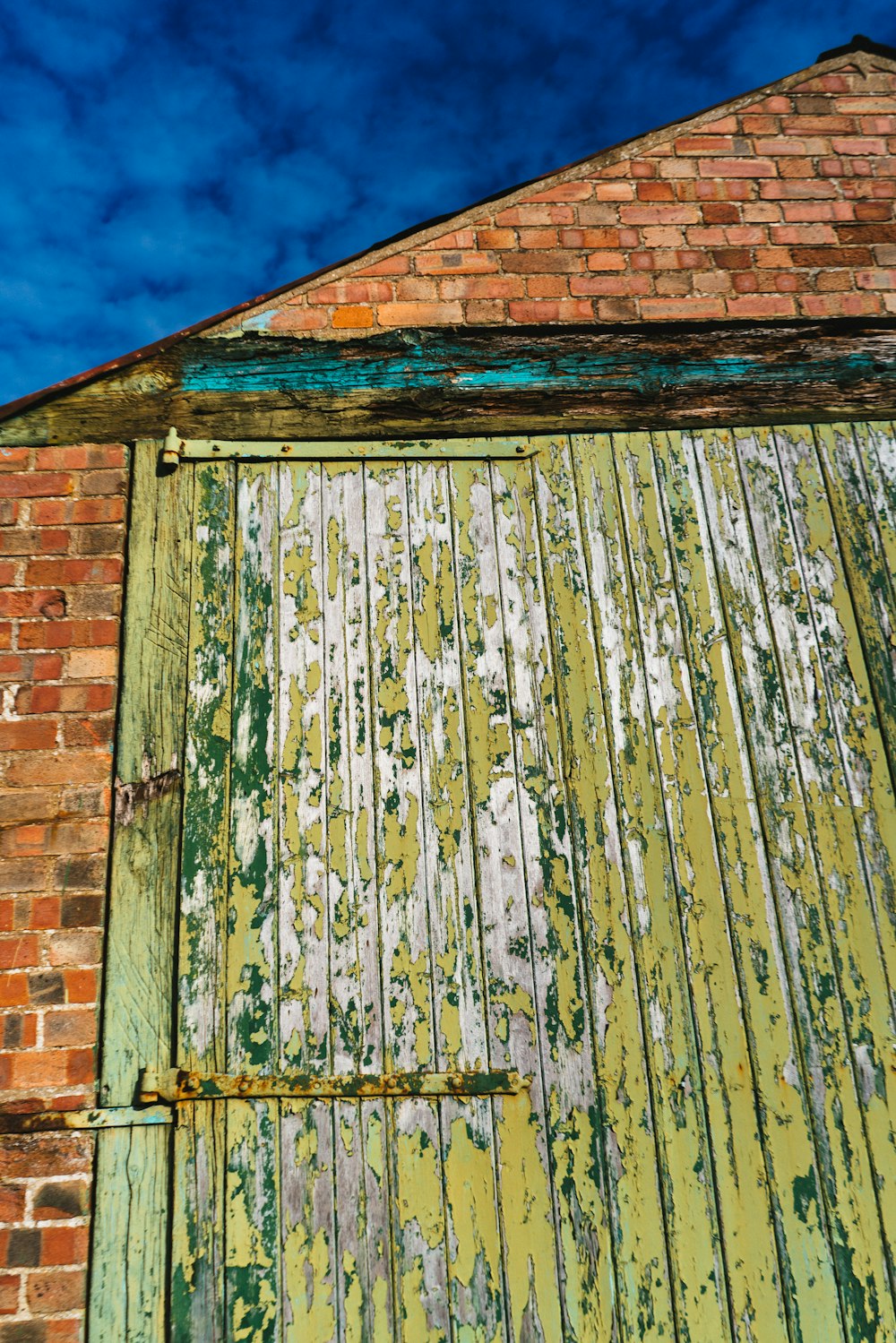 an old brick building with a green door