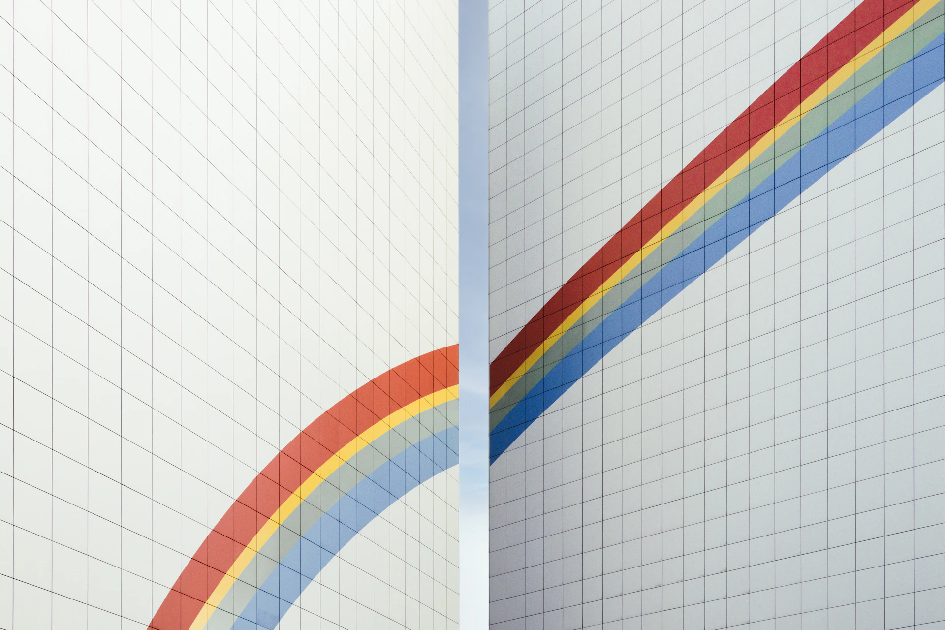 a couple of white walls with a rainbow painted on them
