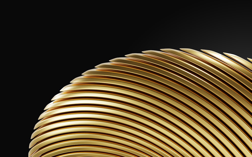 a close up of a gold object on a black background