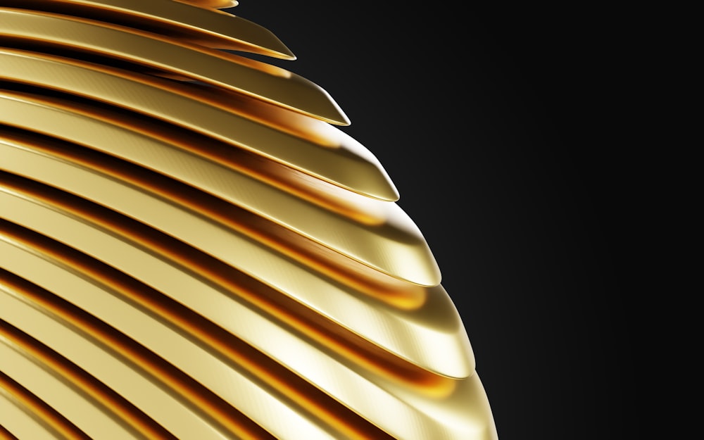 a close up of a gold object on a black background