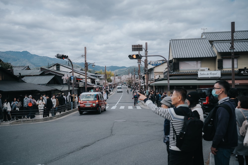 a group of people standing on the side of a road