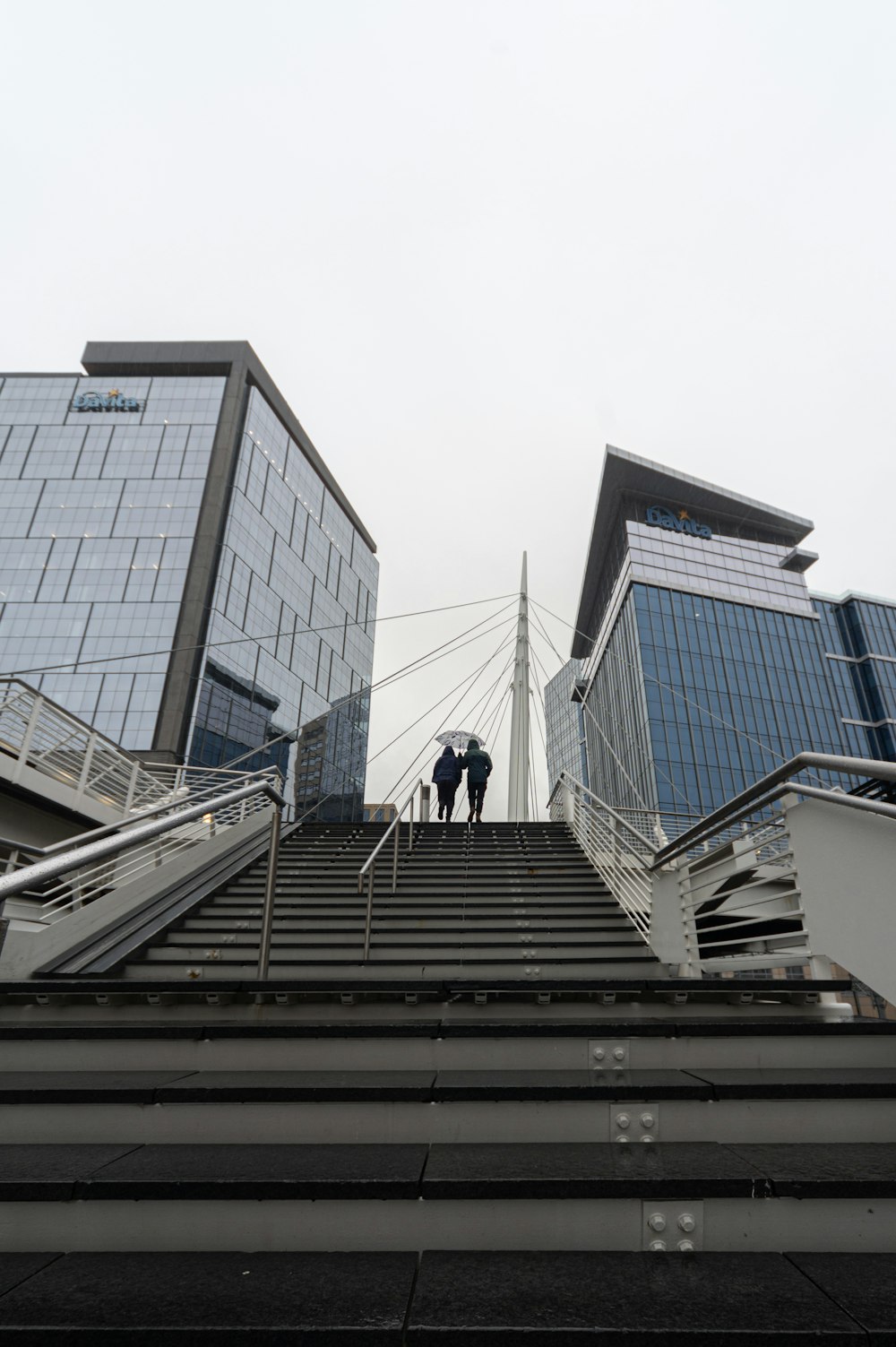 a couple of people that are standing on some stairs