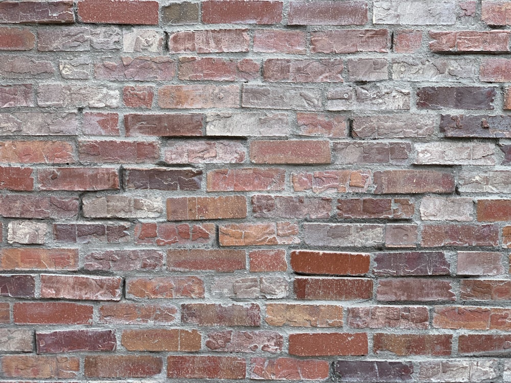 a brick wall made of red and brown bricks