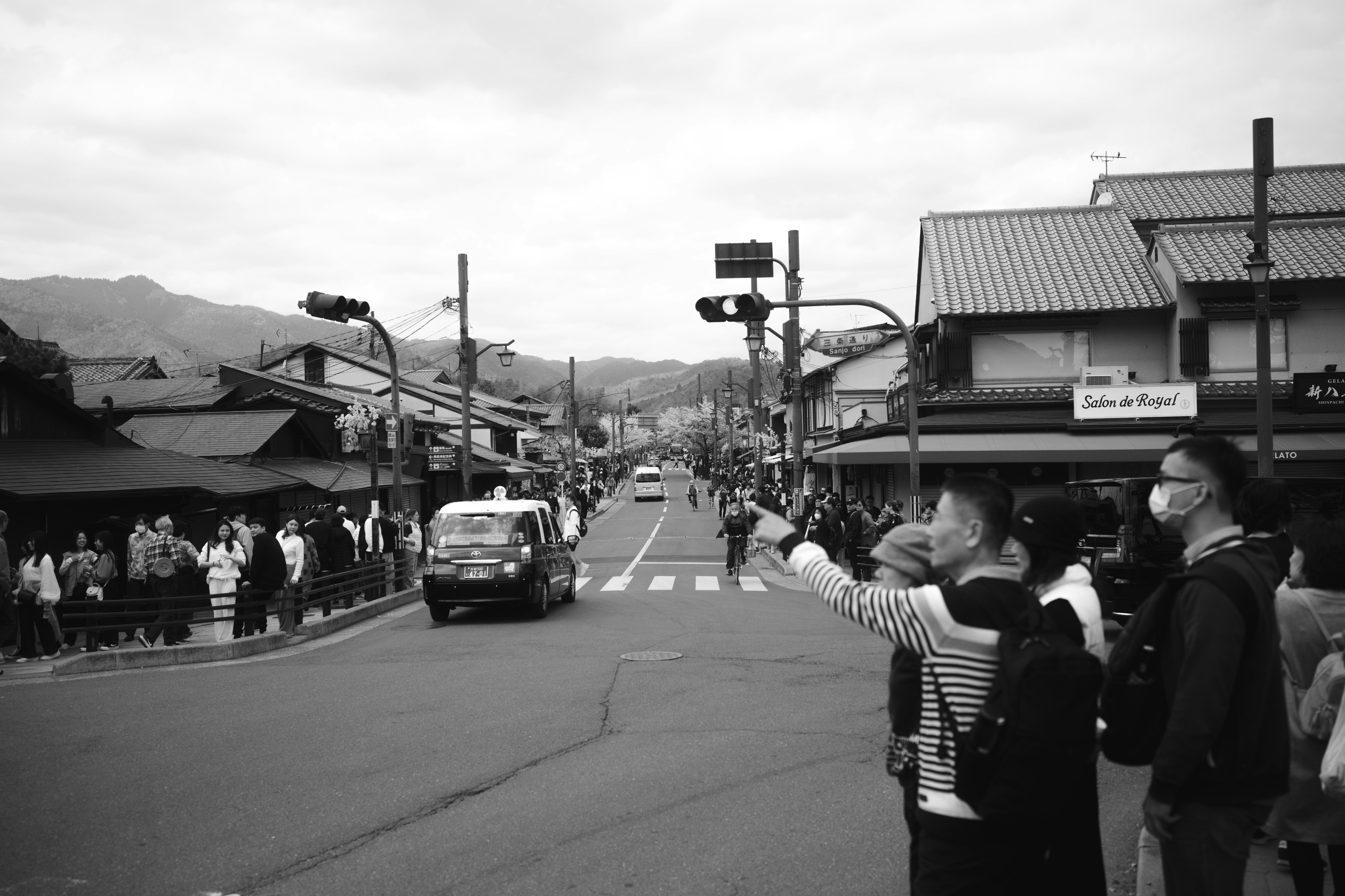 a group of people standing on the side of a road