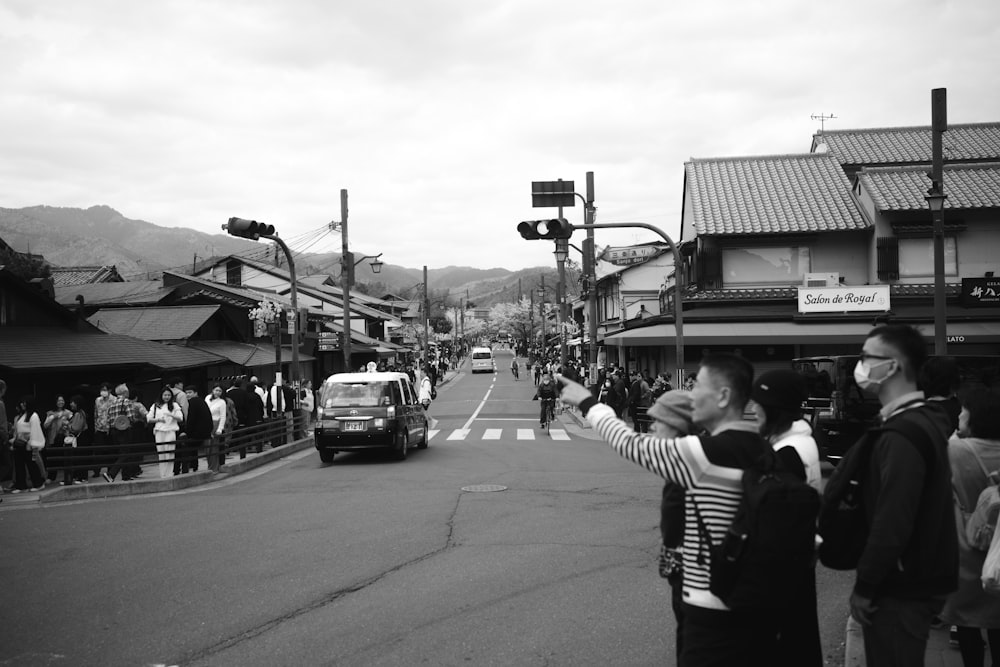 a group of people standing on the side of a road