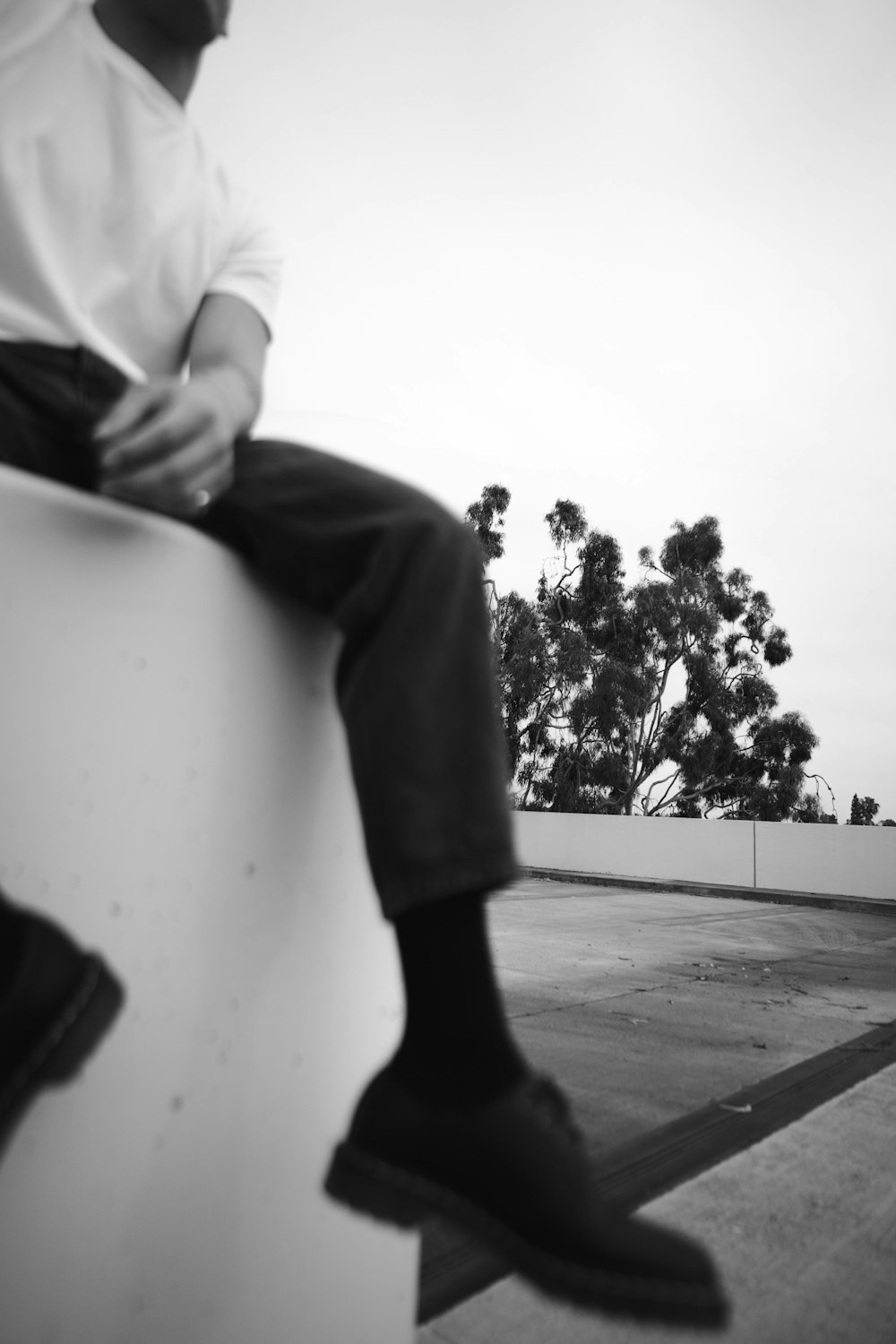 a man sitting on top of a white object