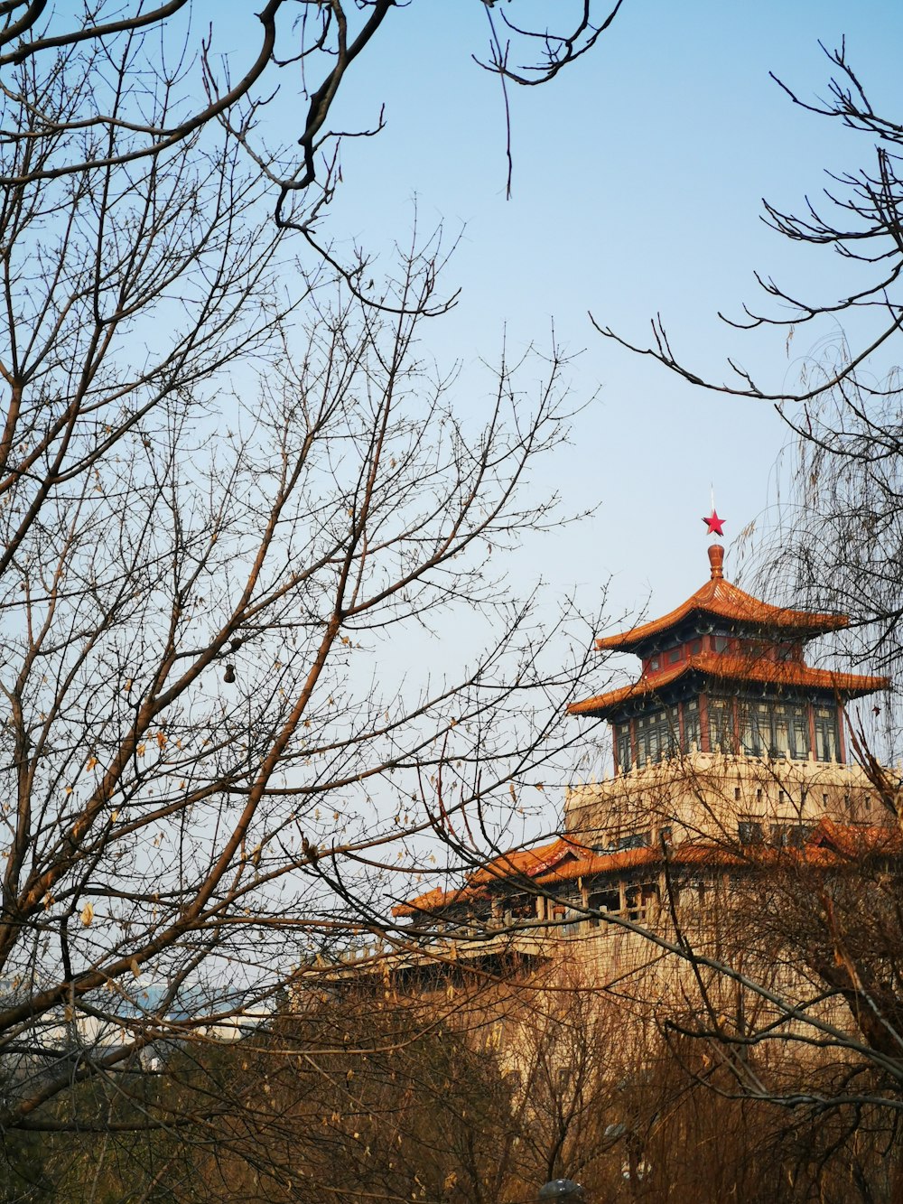 a tall building with a red flag on top of it