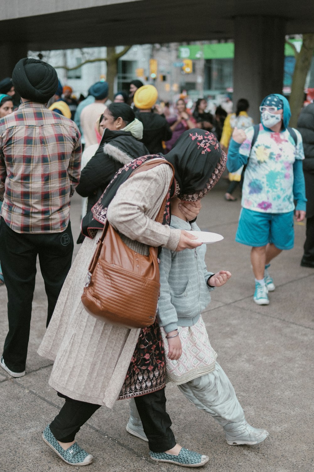 a couple of people walking down a street